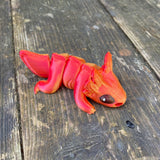 3D printed mini axolotl sea creature in red gold colurway Pilola