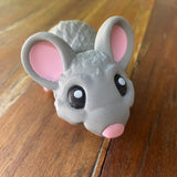 3D Printed Grey Mouse. Designed by Matmires. Printed by Pilola. Close up of face on a wooden background