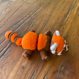Orange Brown and White 3D printed Red Panda. Designed by Matmires and printed by Pilola. Shown on a wooden background Lying down 