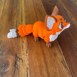 Cute 3d printed Red Fox, printed by Pilola. Shown side view on a wooden background